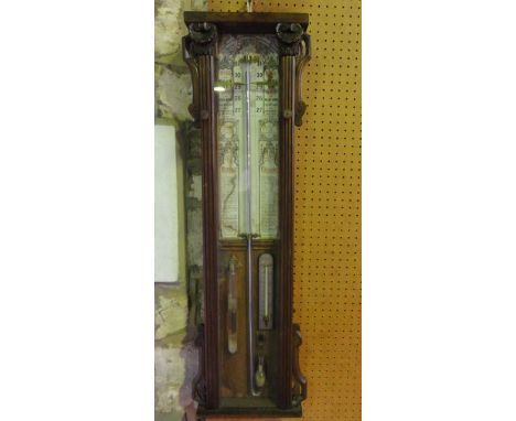 An Admiral Fitzroy barometer in an oak case with carved and applied detail, with printed paper back