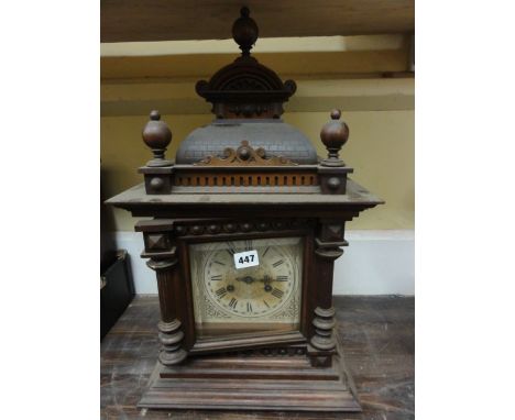 A late 19th century walnut bracket clock, the case with applied spindle mouldings and further carved detail, enclosing a squa