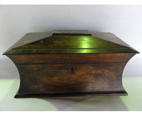 A 19th century rosewood sarcophagus shaped tea caddy, the hinged lid revealing a central well flanked by two compartments wit