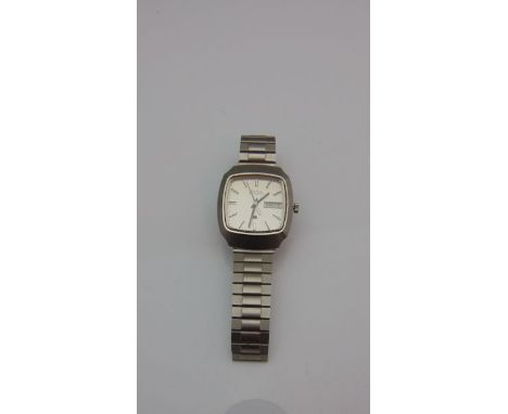 A gentleman's stainless steel wristwatch, Bulova Accuquartz, the cushion-shaped dial with baton numerals, day and date apertu