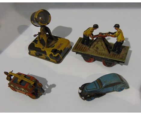 Four pre-war tin plate toys - two push me-pull you trucks, saloon car and search light