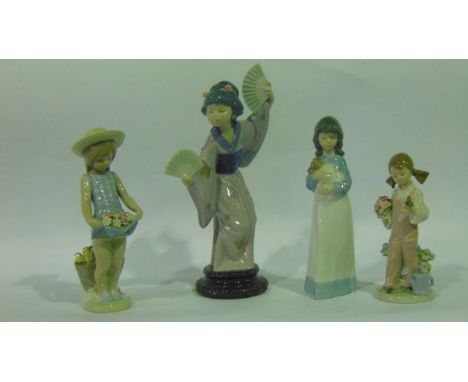 A Lladro Daisa figure of a Japanese girl in traditional costume dancing with a pair of fans together with two Lladro Daisa fi