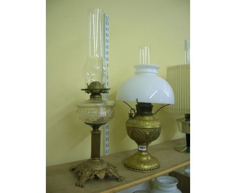 Two American table lamps including a Miller lamp heavily worked body and foot, complete with burner and dome shade, a Plume a