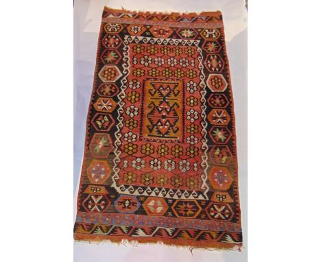 A good quality vintage kelim type rug, with stitched interlocking geometric panelled sections with red ground detailed in sha