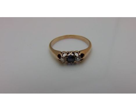 A Victorian style ring, centred with an old-cut untested sapphire, flanked to one side with an old-cut diamond and the other 