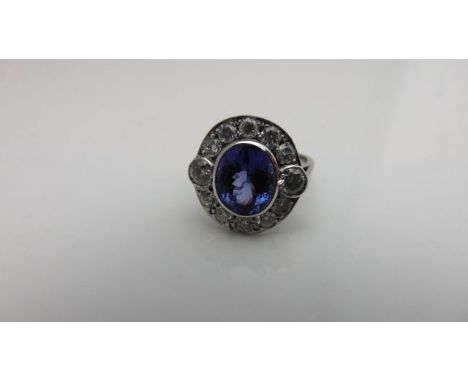 A tanzanite and diamond dress ring, centred with an oval mixed-cut tanzanite weighing approximately 2.50cts, within a surroun
