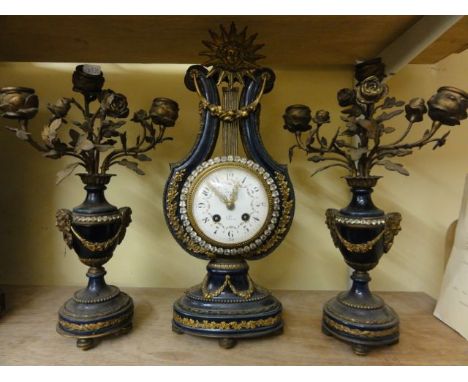 A 19th century clock garniture in blue porcelain, the clock mechanism with 8-day striking movement set within a lyre shaped c