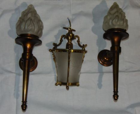 A pair of good quality brass torchere style wall  lights each fitted with a moulded opaque glass shade of flame form, togethe