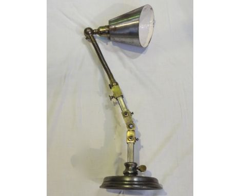 A vintage industrial anglepoise lamp, principally in steel with heavy adjustable brass brackets to the anglepoise stem with f