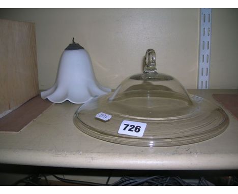 Two oil lamp smoke bells, one of plain glass flattened form approximately 25cm diameter, plus one smaller pottery bell suitab