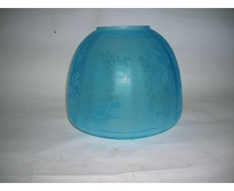 A contemporary blue glass beehive shade for oil lamp with transfer etched design of flowers and butterflies