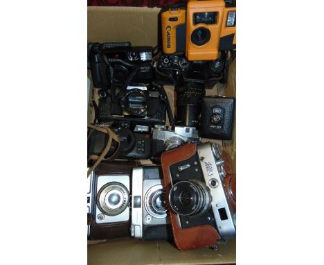 A box containing an assortment of vintage cameras to include a Zenit Em camera fitted with a Pentacon lens, further cameras b