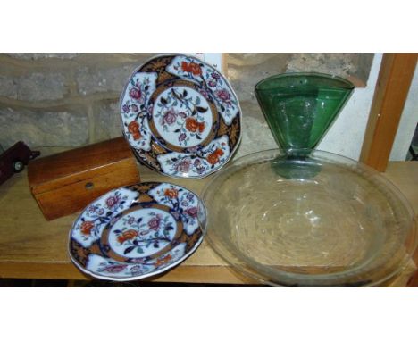 Two similar ironstone plates with floral detail and gilded highlights, a large clear glass of shallow circular form with etch