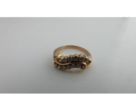 A diamond ring, centred with a scrolling motif highlighted with a row of round brilliant-cut diamonds on each side weighing a