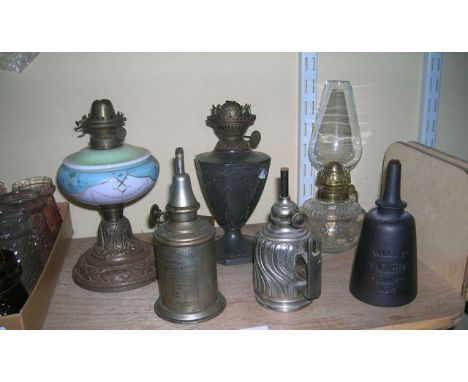 Six small lamps to include a Wells cast iron engineers' lamp No 4, a pressed glass hand lamp with burner and chimney, a Frenc