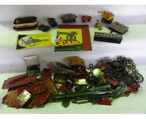 An assortment of vintage Meccano to include numerouse plates, wheels, etc, a small printed tin containing numerous Meccano fi