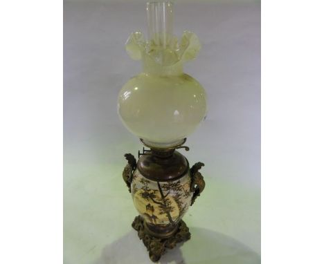 A Victorian oil lamp, the baluster shaped ceramic font with painted decoration of a castle before a lake and mountainscape,  