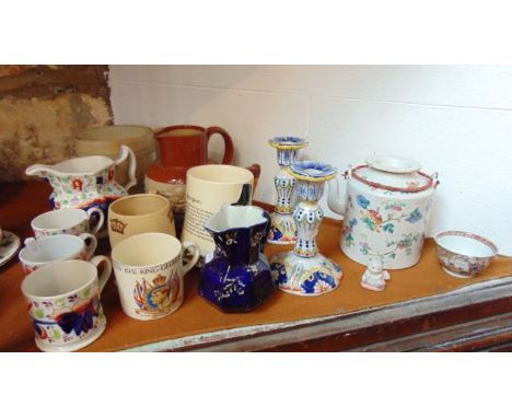 A collection of ceramics including a pair of continental tin glazed earthenware candlesticks with polychrome painted decorati