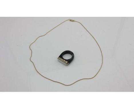 A black jade ring, highlighted with a mother-of-pearl plaque, 14ct gold mount, size O 1/2; and a 9ct gold snake link chain, 2