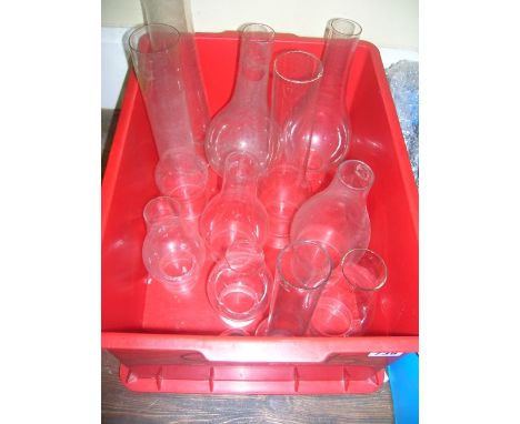 A collection of various oil lamp chimneys, approximately twelve in total including slip bulge, lox-on Aladdin chimney and var