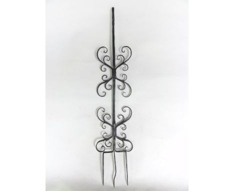 A well made antique ironwork, three pronged fork with twisted central handle flanked by symmetrical scrolling branches, 57 cm