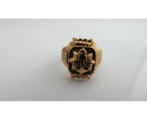 An unmarked gold ring, centred with an anchor motif, the shoulders with ribbed decoration, 10.1g, size S 1/2