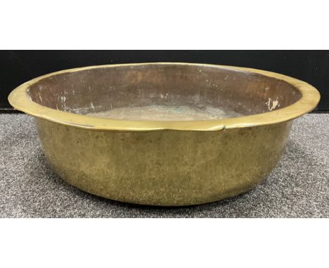 A large 19th century hand-planished brass basin, 21.5cm high x 68cm diameter.