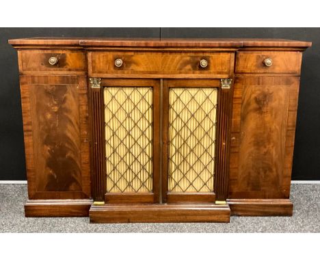 A Regency style mahogany break-centre Chiffonier, with brass stringing to the slightly over-sailing top, above a single long 