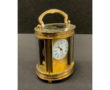 An Elliott &amp; sons of London miniature oval brass cased mantel time piece, white enamel dial, blue roman numerals, floral 