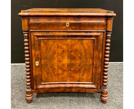 A Biedermeier style flame mahogany cabinet, shaped top, slightly inverted-bow front with single drawer to the frieze. Bobbin-