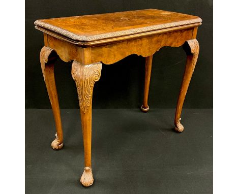 A Georgian style walnut and burr walnut card table, lift-over top with baize playing surface to interior. Shaped frieze, carv
