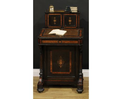 A Victorian amboyna, ebonised and marquetry music room Davenport desk, canted rectangular superstructure with a pair of panel