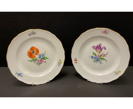 A pair of Meissen botanical plates, each decorated with bouquets, shaped gilt rims, blue crossed swords and impressed marks, 