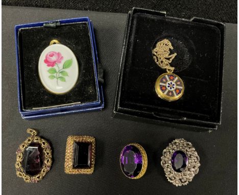 An oval vibrant purple amethyst yellow metal mounted brooch, unmarked, 13.9g gross;  another silver coloured metal with flora