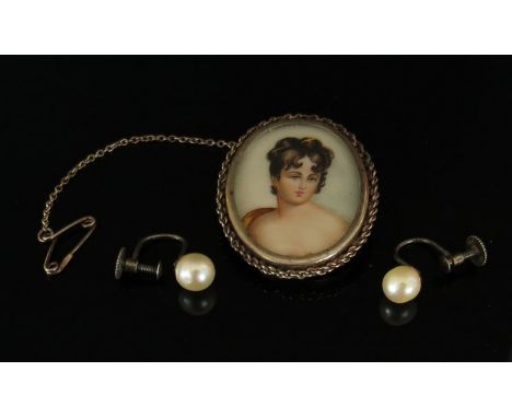 A brooch depicting a hand painted portrait of a young lady on ivory, stamped 800 with a pair of screw back pearl earrings