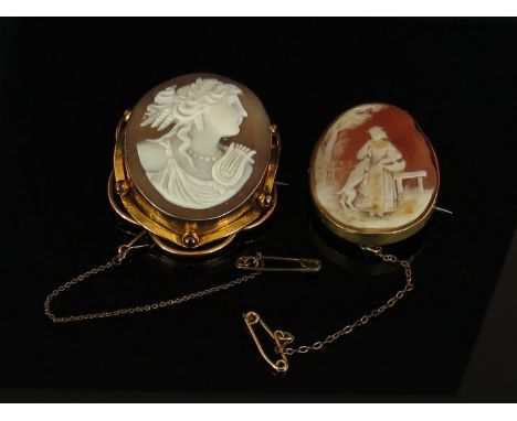 A Victorian shell cameo brooch depicting a lady in garden with her dog, stamped 9ct and another with bust of a maiden with ly