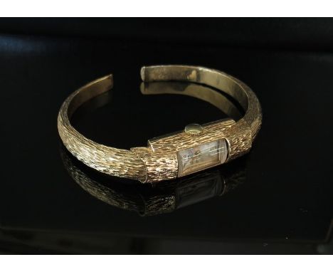 A WS 9ct gold bark effect bangle watch, 16.9g