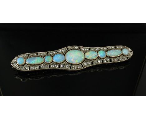 A Victorian platinum set opal bar brooch, the nine oval and circular stones up to 13mm approx diameter set within yellow gold