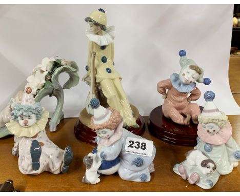 Three Lladro porcelain figures of clowns, H. 12cm. Together with a Lladro figure of a young fairy asleep in a leaf and two Na