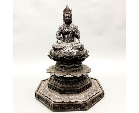 A large Sino-Tibetan bronze figure of a crowned Buddha on a lotus throne, H. 46cm.