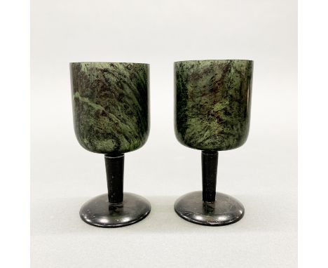 A pair of Chinese carved spinach jade wine goblets, H. 12cm.