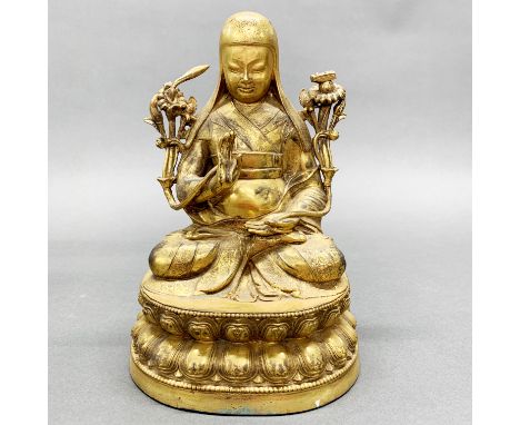 A Tibetan gilt bronze figure of a seated Lama, H. 24cm.