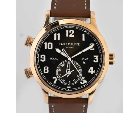 Standard VAT PATEK PHILIPPE; a gentleman's 18ct rose gold Calatrava Pilot Travel Time wristwatch, with Arabic numerals and su