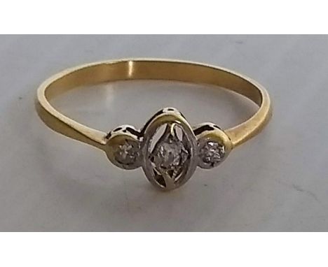A three-stone diamond ring centrally set with an old mine-cut diamond and flanked by old-cut diamonds. Total diamond weight e