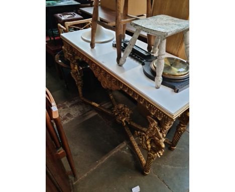 A gilt wood and composite top console table decorated with lady figures and cherubs. 