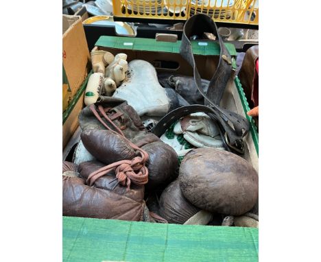 A box of vintage leather sports equipment - boxing gloves. ice skates, cricket gloves etc 