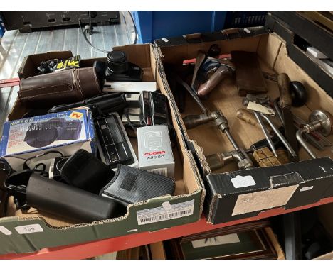 A box of camera equipment and a box of vintage tools. 