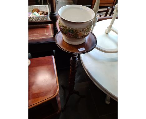 A mahogany twist plant stand and ceramic planter. 