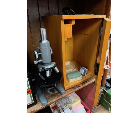 A vintage microscope model L-201 in wooden box together with extra lenses. 