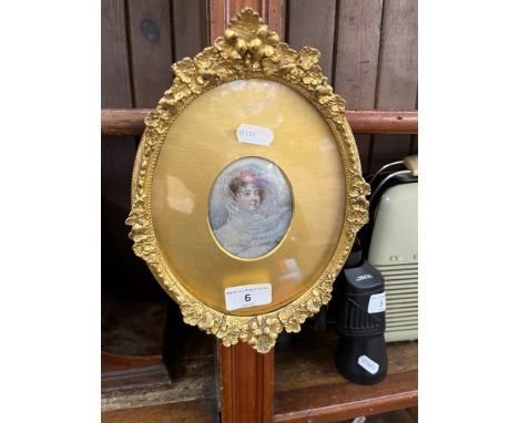 A 19th century miniature portrait of a lady, in gilt oval frame.This is a painting not a print. 
